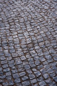 Detailed cobblestone street texture showcasing unique stone pattern for design backgrounds.